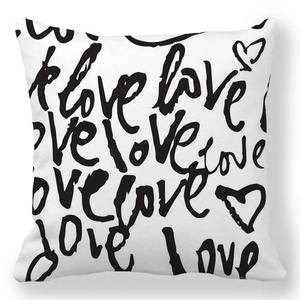 Detail of soft peach skin cushion cover with black handwritten love and heart prints