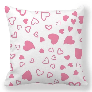 Detail view of square white pillowcase featuring romantic pink heart patterns in peach skin fabric