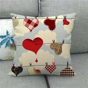 Linen pillowcase detail showing hearts on clothesline against a blue cloud background