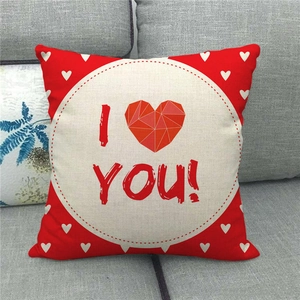 Red linen Valentine's Day pillow cover with heart pattern and I Love You text on sofa