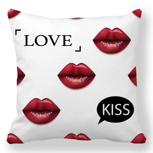 Detail of peach skin pillowcase with red lip prints and LOVE KISS typography design