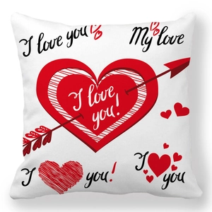 Detail of soft peach skin cushion cover with red heart arrows and I Love You text
