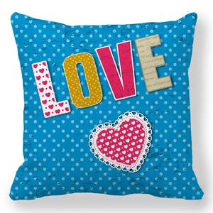 Detail of vintage blue Love cushion cover with heart lace pattern and polka dots texture