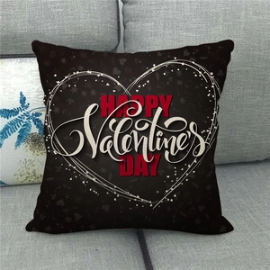 Detail view of Valentine's Day linen pillowcase with red heart and text on black fabric