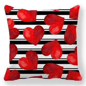 Detail of red watercolor hearts over black and white striped peach skin pillowcase