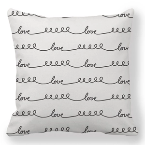 Detail of soft peach skin cushion cover with black handwritten love text and wave pattern