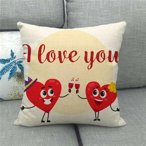 Close-up of linen pillow cover with I Love You heart characters on a grey sofa