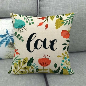 Detailed close-up showing the linen texture and colorful Love flower print on a white pillow