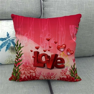 Detail of red Valentine linen pillowcase with 3D Love text and hearts on a grey sofa