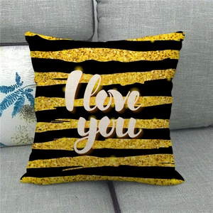Close-up of black and gold striped linen pillowcase featuring I love you artistic print