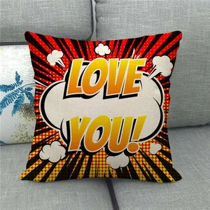 Detail of linen pillowcase with retro pop art LOVE YOU design on gray sofa decor