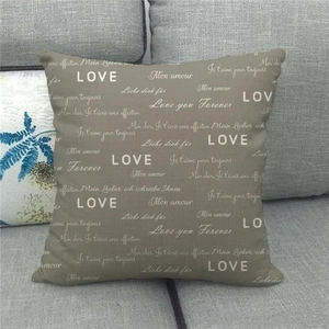 Detail of linen pillow cover featuring multi-language Love and Mon Amour prints