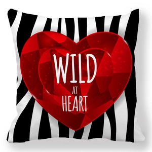 Zebra print pillow case with a red ruby heart and Wild at Heart text on white background