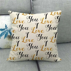 Detail of linen pillowcase with I Love You lettering and gold glitter text on gray sofa