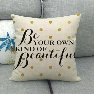 Close-up of linen pillowcase with Be Your Own Kind Of Beautiful text and gold dots