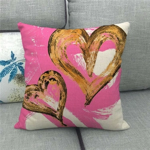 Artistic linen pillow cover with golden heart brushstrokes on a pink background