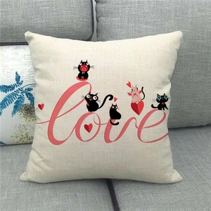 Close-up of linen pillowcase texture featuring red Love text and cute cartoon cats