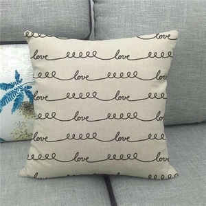Close-up of linen pillowcase featuring a minimalist black cursive Love design