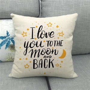 Close-up of linen cushion cover with I love you to the moon and back text on sofa