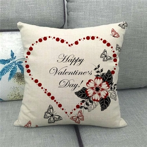 Close-up of linen pillowcase with Happy Valentine's Day print on a grey sofa
