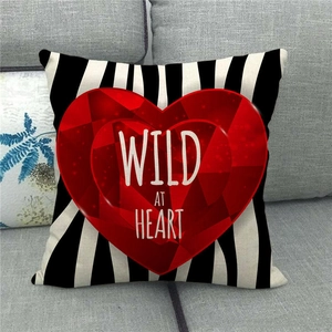 Detail of linen pillowcase with black stripes and red heart featuring Wild At Heart slogan