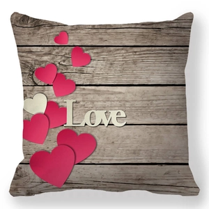 Detail of wooden texture pillowcase with red hearts and white Love text for Valentine