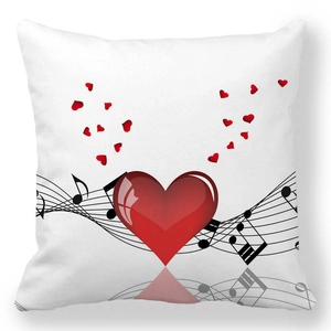 Detail of red heart pillowcase featuring musical notes and a sleek satin texture