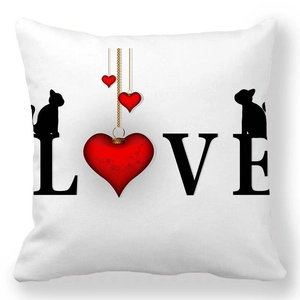 Detail of white square pillowcase with LOVE print, red heart, and black cat silhouettes