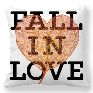 Detail of white peach skin pillowcase with orange leaf and FALL IN LOVE text print
