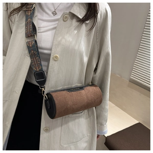 Detail of cylinder bag with fashion text and ethnic pattern wide shoulder strap