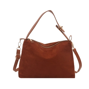 Vintage brown suede handbag with adjustable shoulder strap and gold hardware on white background