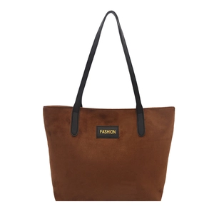 Vintage large brown tote bag with matte texture and black straps on white background