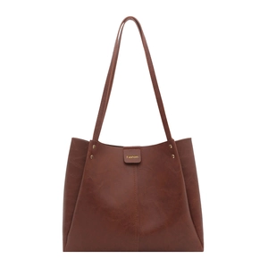 Brown vintage faux leather tote bag with embossed texture and gold fashion lettering