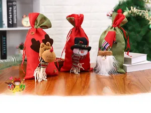 Close-up of burlap Christmas gift bags with 3D Santa, Snowman and Reindeer plush figures
