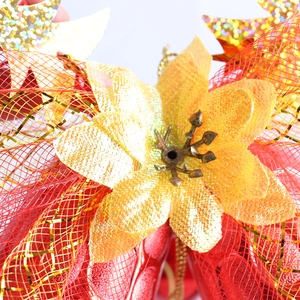 Macro view of artificial Christmas flower decoration with red mesh and gold glitter petals