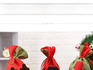 Detail view of festive Christmas drawstring gift bags featuring cute elk and Santa patches