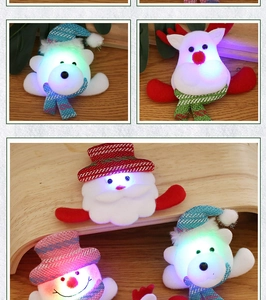 Detail of Christmas LED glowing brooches featuring Santa, reindeer, and snowman characters