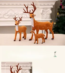 Three plush reindeer ornaments in different sizes displayed near a white fireplace