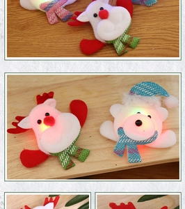Close-up of glowing plush Christmas brooches featuring reindeer and polar bear designs