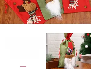 Detail of linen Christmas gift bags with 3D Santa and reindeer decor and drawstring closure
