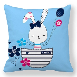 Close-up of Easter bunny and heart embroidery on light blue peach skin pillowcase
