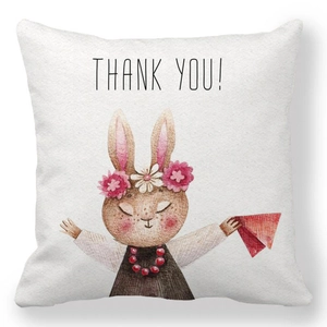 Détail de la housse de coussin en peau de pêche avec lapin aquarelle et texte Merci