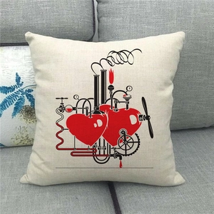 Close-up of linen cushion cover featuring industrial mechanical red heart on a grey sofa