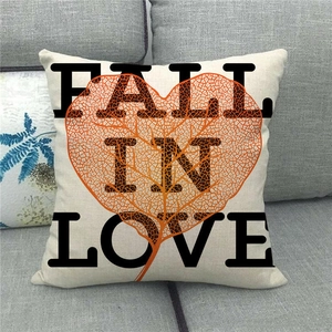 Linen Valentine cushion cover with Fall In Love text on a modern grey sofa