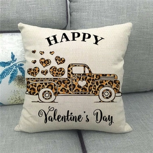 Detail of linen Valentine's Day pillow cover featuring a retro truck and leopard hearts