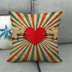 Detail of linen pillowcase featuring red heart and golden Cupid silhouettes in vintage style