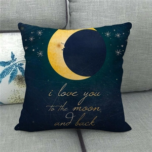 Close-up of linen cushion cover with Moon and Back text on a grey fabric sofa