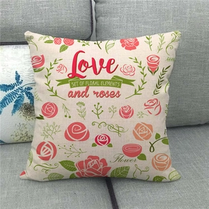 Close-up of linen blend pillow cover with red rose print and decorative Love lettering