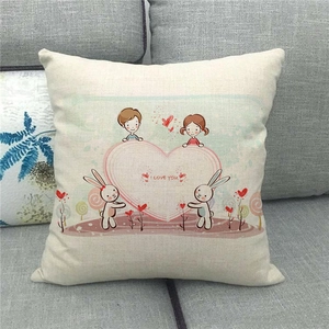 Close-up of linen pillowcase with I Love You couple illustration on a grey sofa
