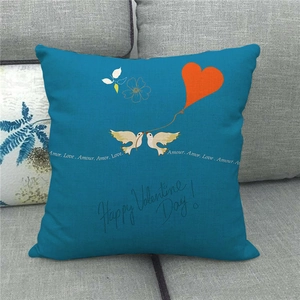 Close-up of linen pillowcase with blue background and Happy Valentine's Day bird pattern